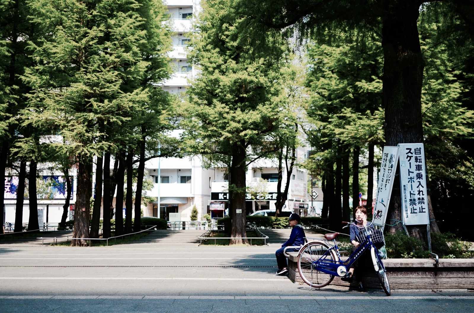 Photo of Ikebukuro, Japan (woman sitting on concrete block photo by chatnarin pramnapan)